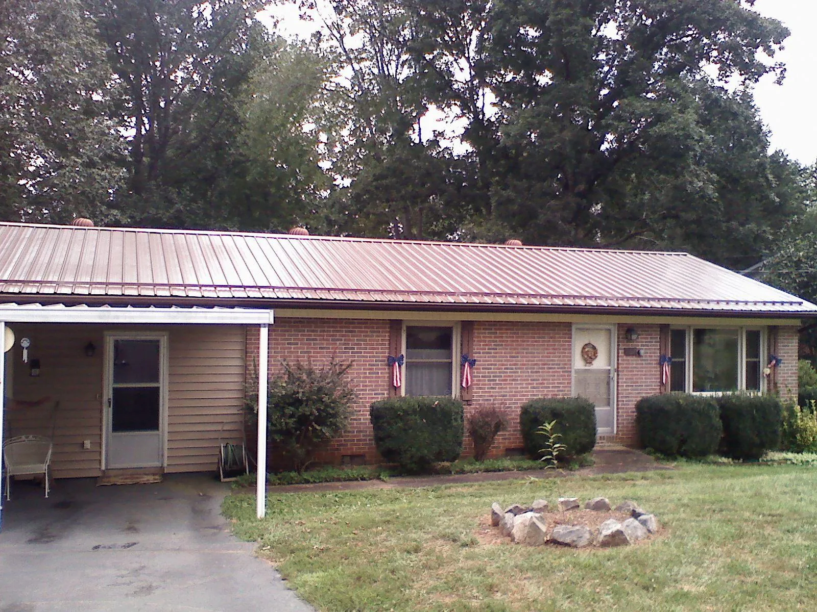 Bronze metal roof and carport on a brick ranch home — Roof Repair work by our crew in Cressona